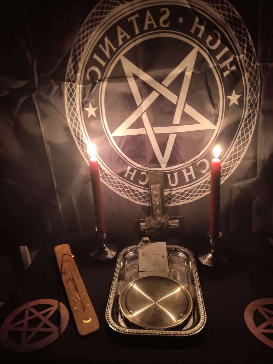 A ritual and devotional setting with candles and symbolic objects